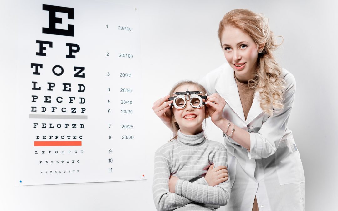Young girl smiling while undergoing eye test with phoropter